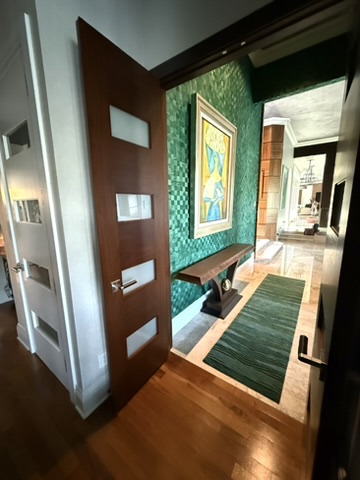 Chaise lounge and reading corner in the primary bedroom beside tall windows