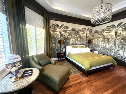 Green music lounge with grand piano, conversational seating, and high ceiling