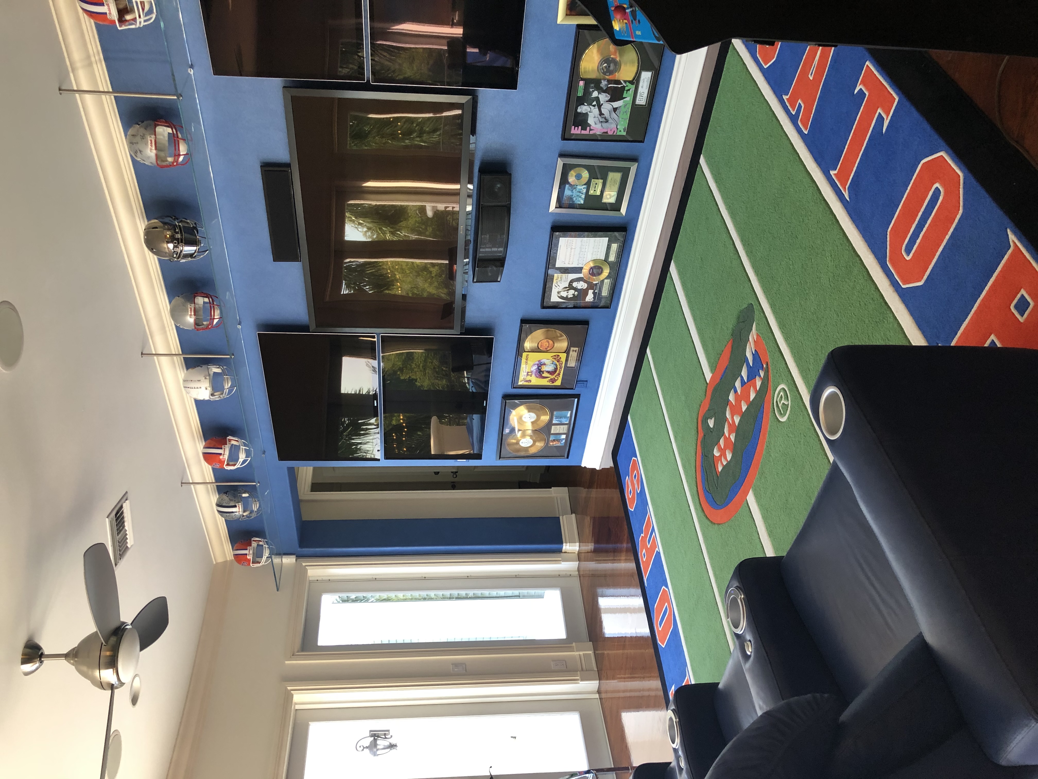 Personalized media room with multiple screens and sports-themed design