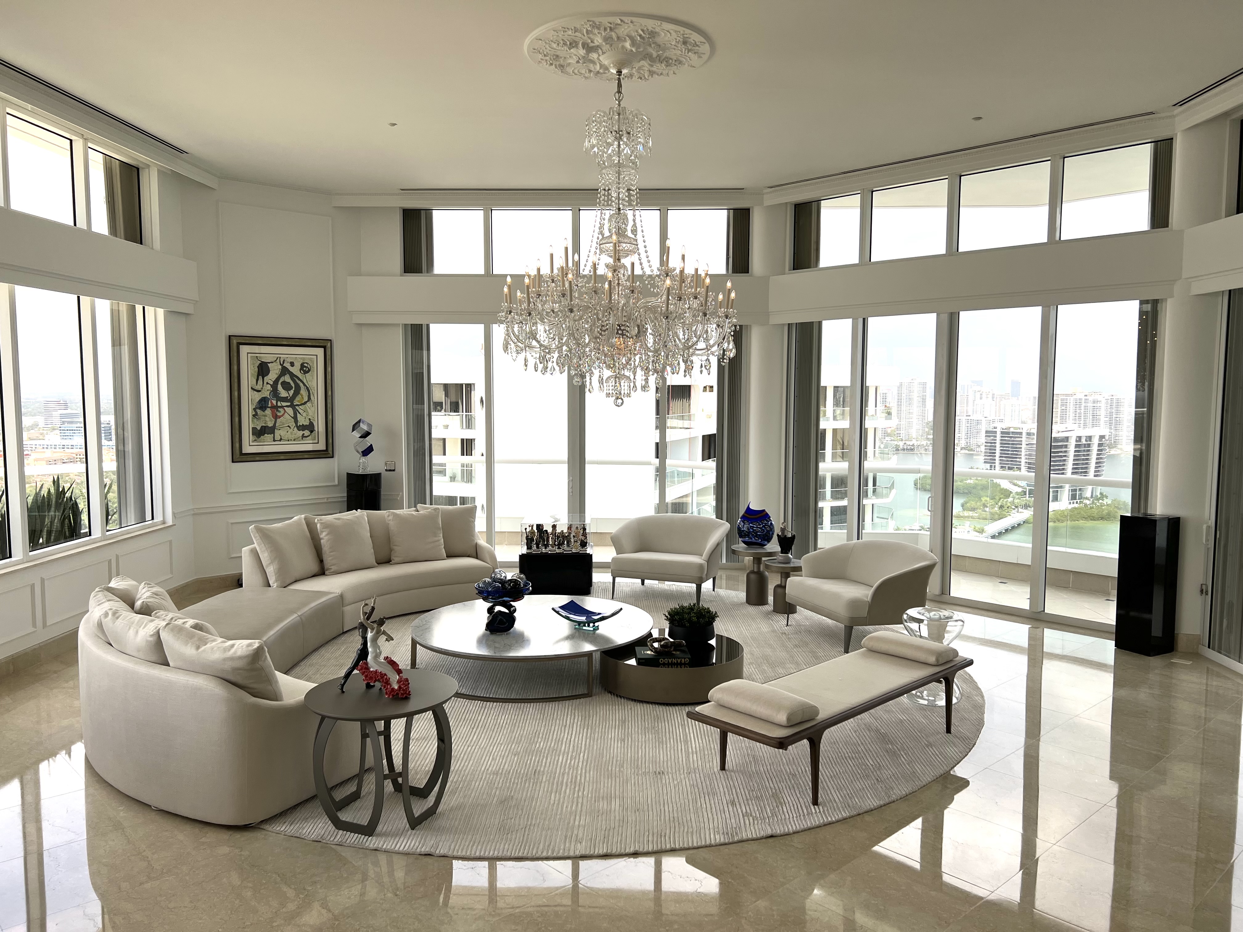 Luxury contemporary living room with chandelier and panoramic windows