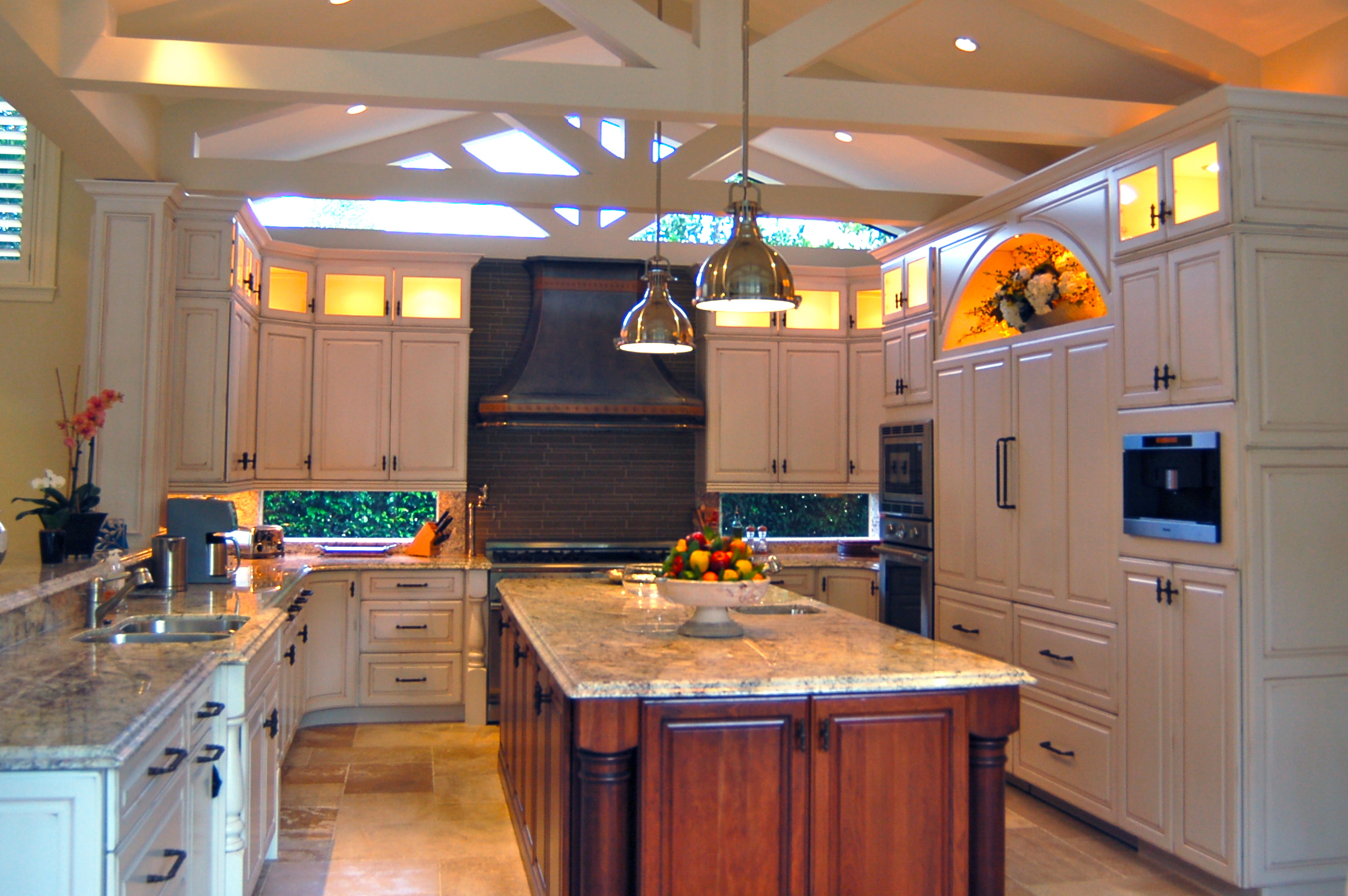 Custom kitchen with large island, classic millwork, and pendant lighting