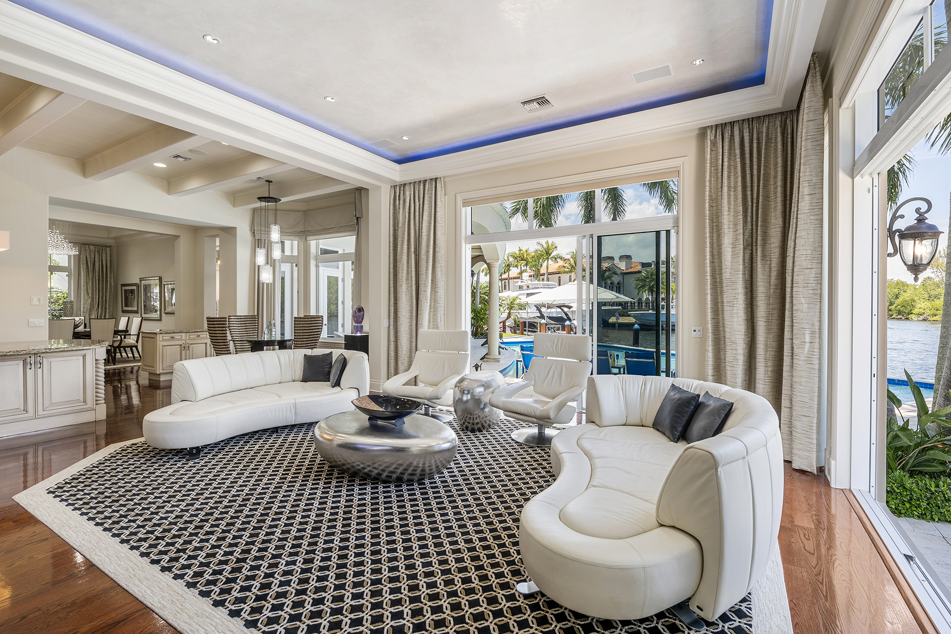 Living room with sculptural seating and pool-facing glass