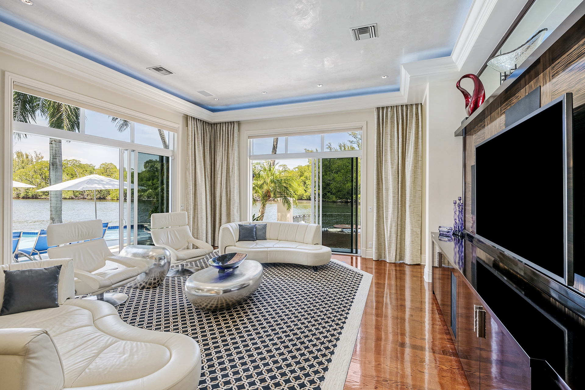 Alternate living room view with media wall and waterfront exposure