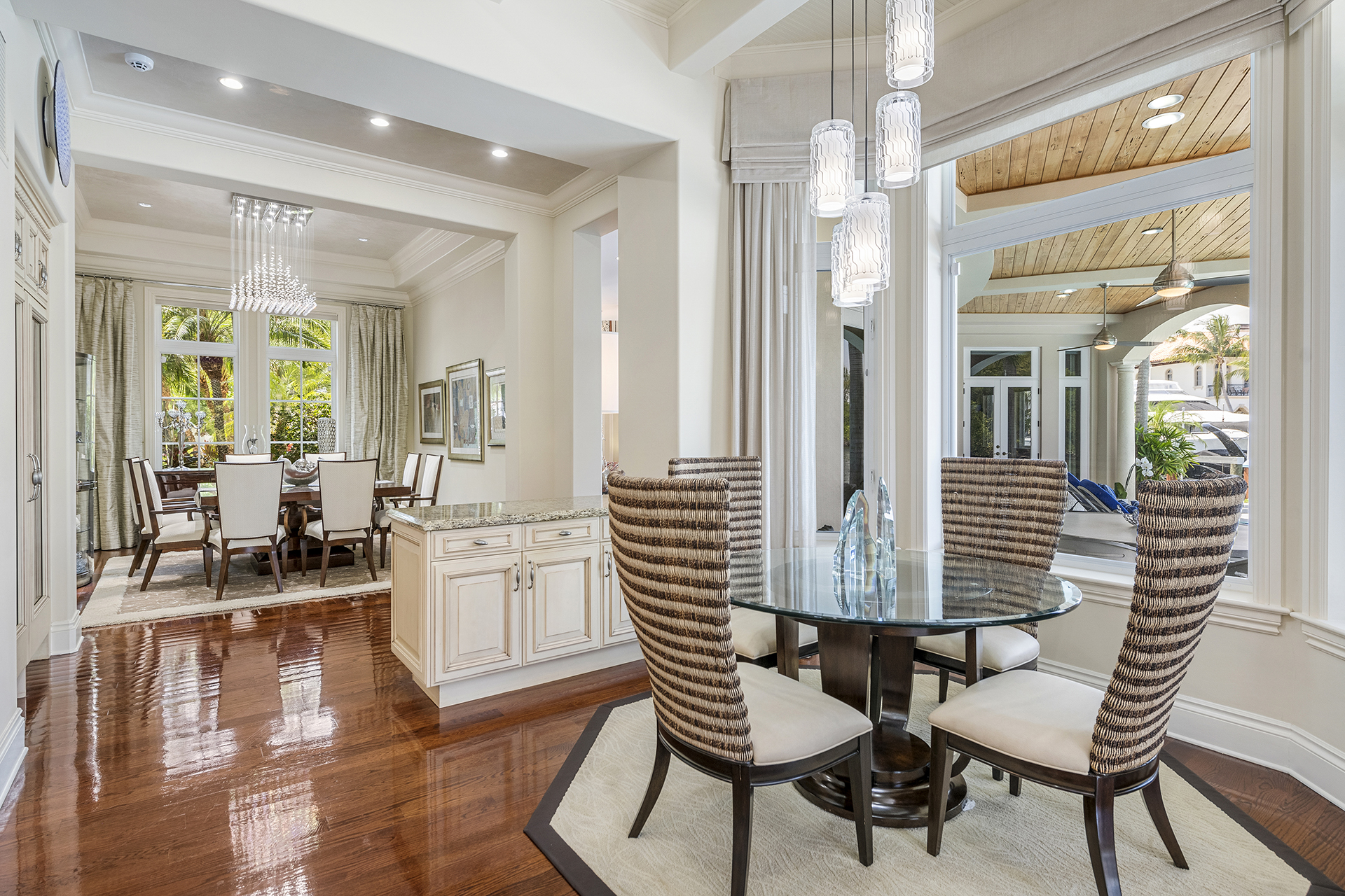 Casual dining area with textured chairs and view to terrace